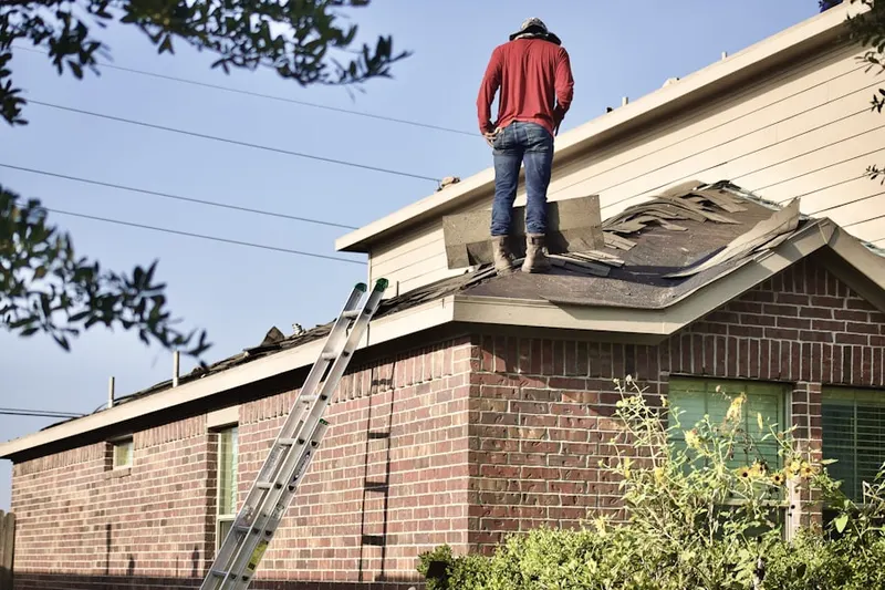 Professional roofer working on a residential roof in Fairfield